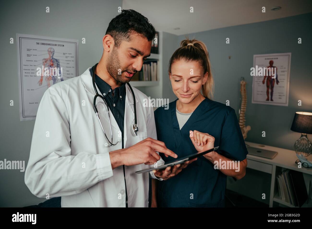 Diverse couple of doctor and nurse standing in clinic Stock Photo