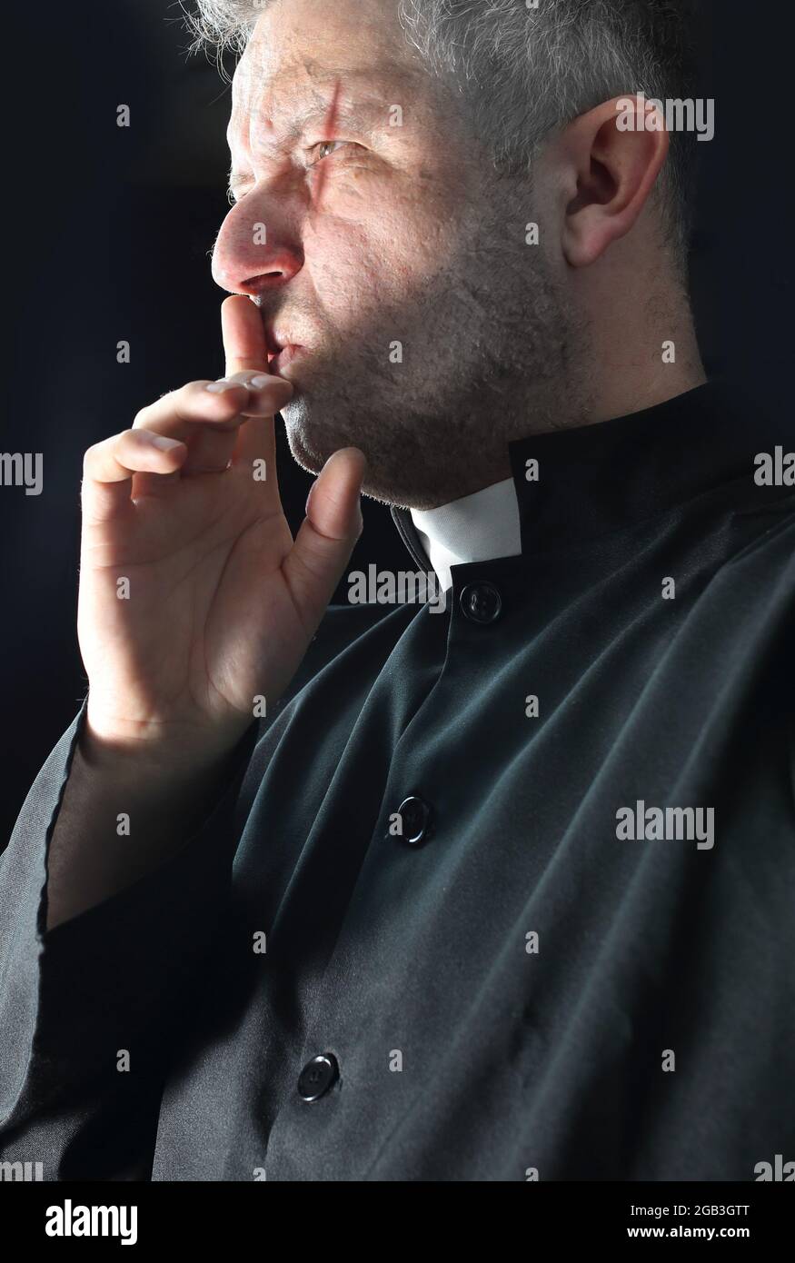 mysterious and silent priest keeps some secret and secret Stock Photo