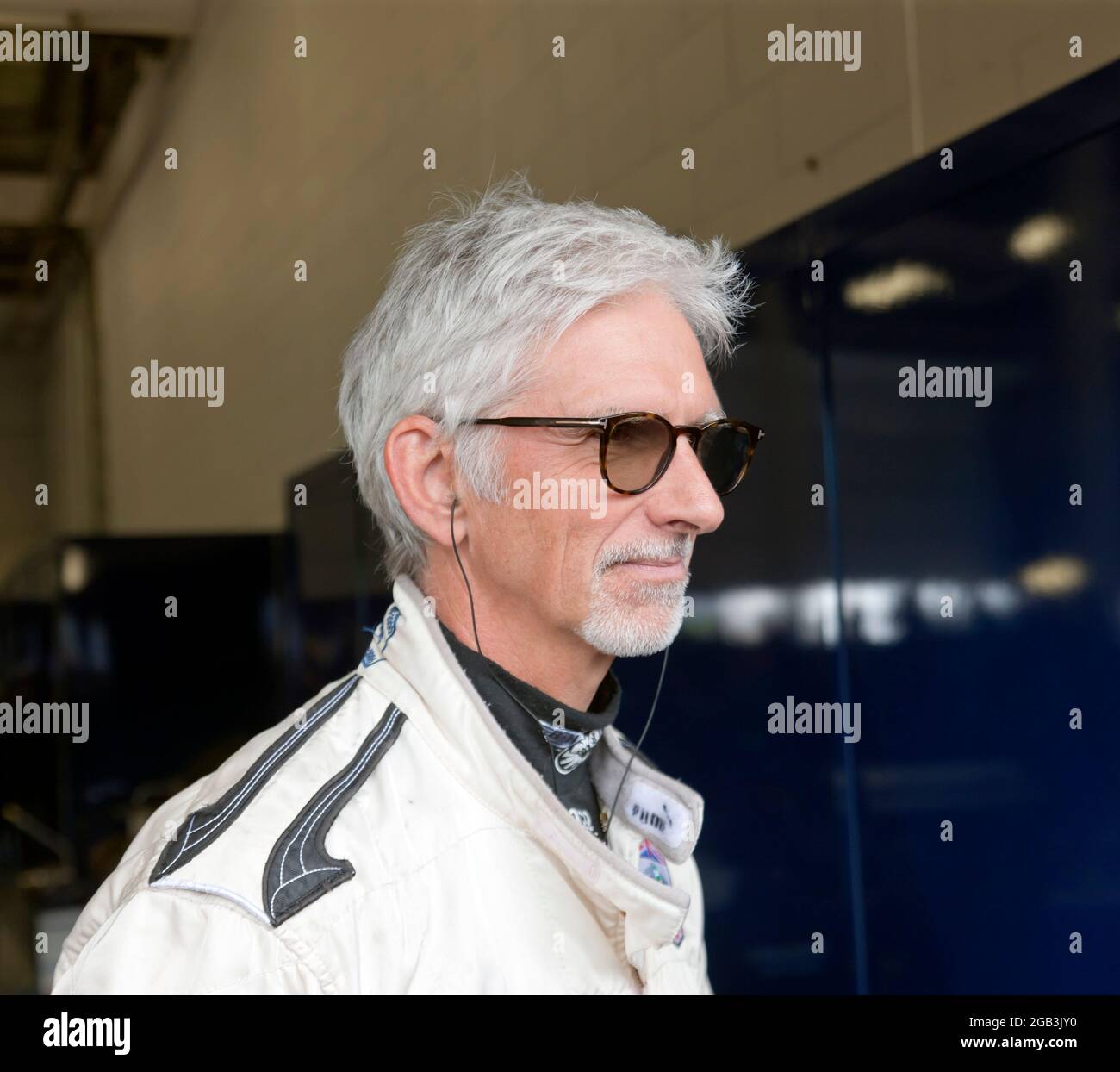 Close-up of Damon Hill OBE, in  Pit Garage 27, at the Silverstone Classic 2021, just before he gave a demonstration of his Championship Winning Williams FW18 Formula One Car Stock Photo
