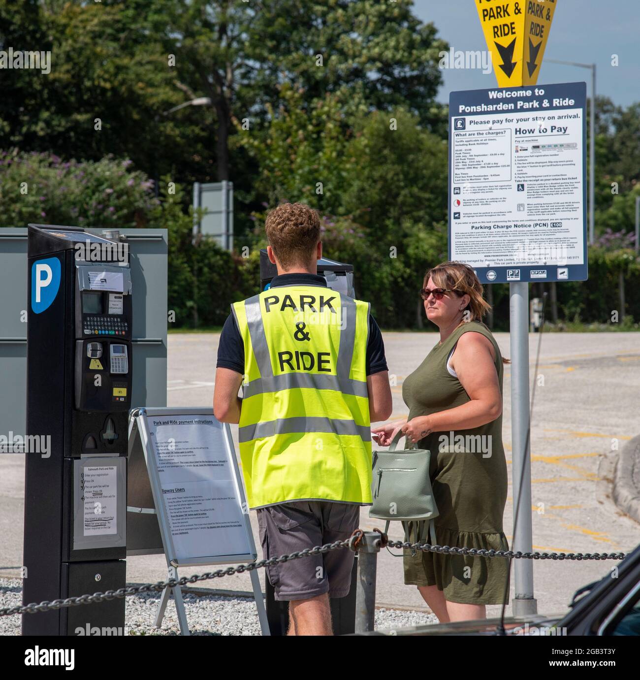 Falmouth, Cornwall, England, UK. 2021. Park & Ride assistant at Falmouth talking with a female