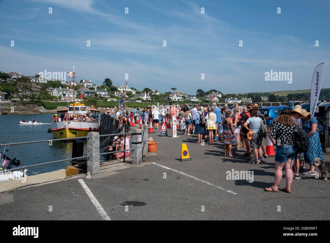 St Mawes, Cornwall, England, UK. 2021.  Passengers queue for the ferry to Falmouth on the harbour at St Mawes a popular tourist coastal town. Stock Photo