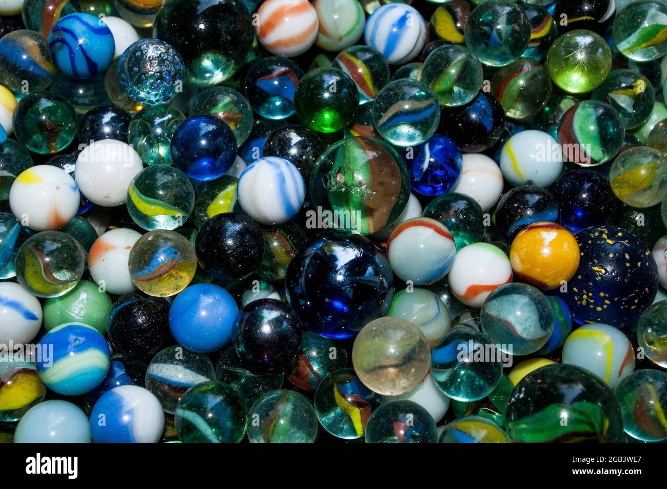 Colorful glass marbles of different sizes in a color pattern Stock