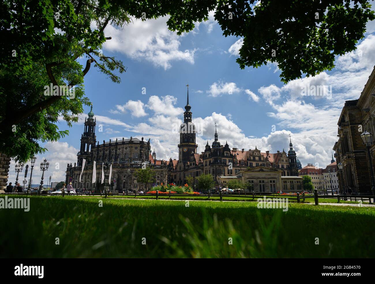 02 August 2021, Saxony, Dresden: Sunshine and clouds decorate the picture of the city on the Theaterplatz with the Hofkirche (l-r), the Hausmannsturm, the Residenzschloss and the Schinkelwache. Photo: Robert Michael/dpa-Zentralbild/dpa Stock Photo