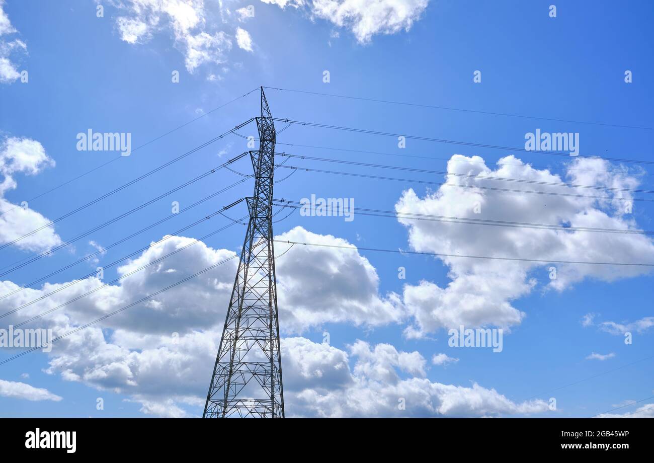 Power line support with cables for transmission of electricity. High voltage network tower with cable wire at the distribution station. energy industr Stock Photo