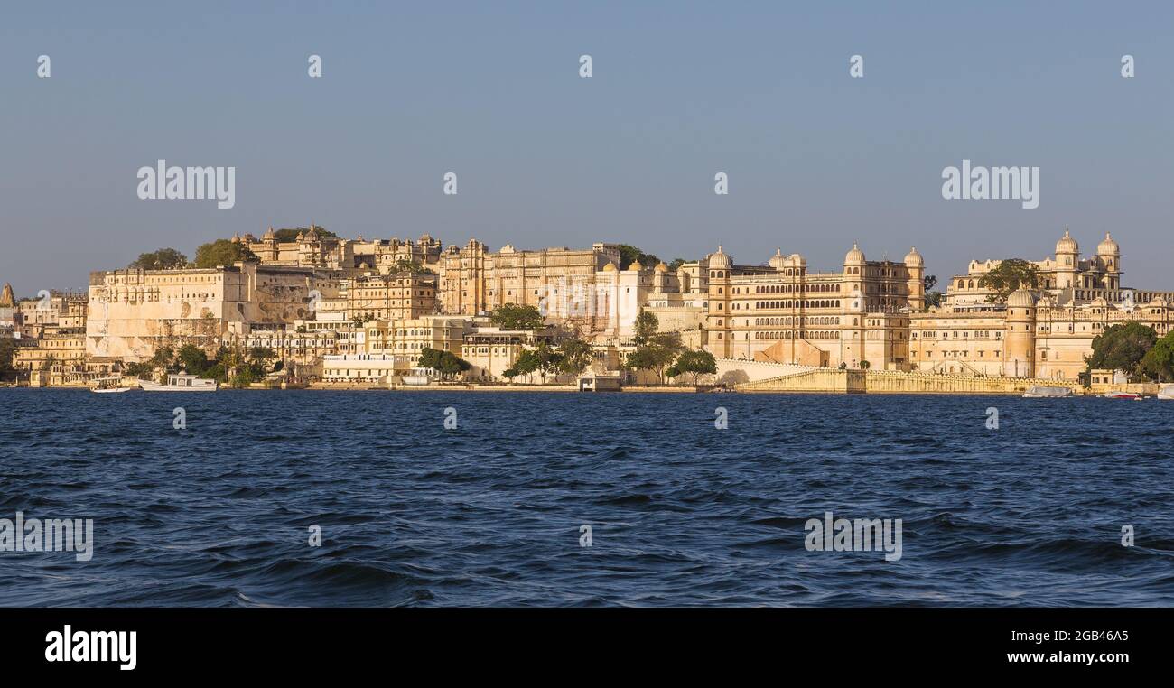 A panorama or Udaipur from Lake Pichola during the day. Part of the palace can be seen. Stock Photo