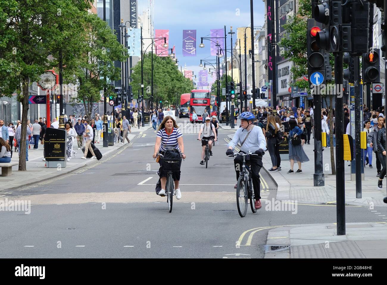 Cyclists ride along London's Oxford Street which is largely traffic free aside from major bus routes operating through the area. Stock Photo