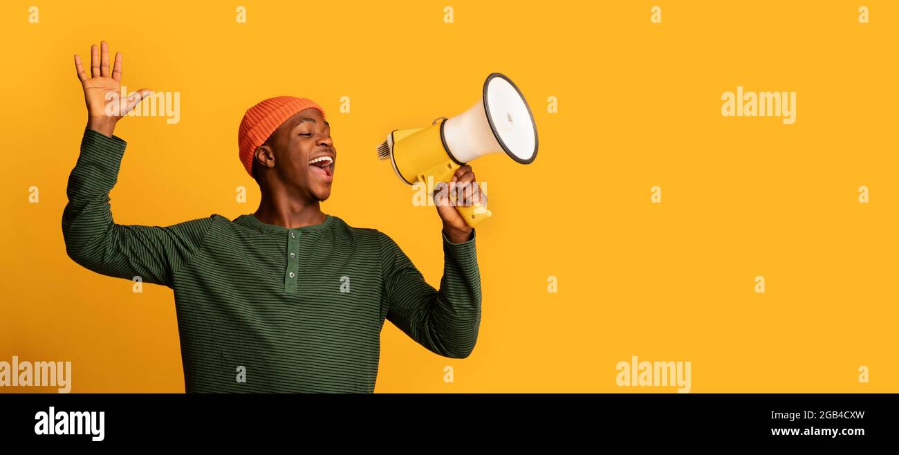 Big Sale Announcement. Portrait Of Cheerful Black Guy With Megaphone In Hands Stock Photo
