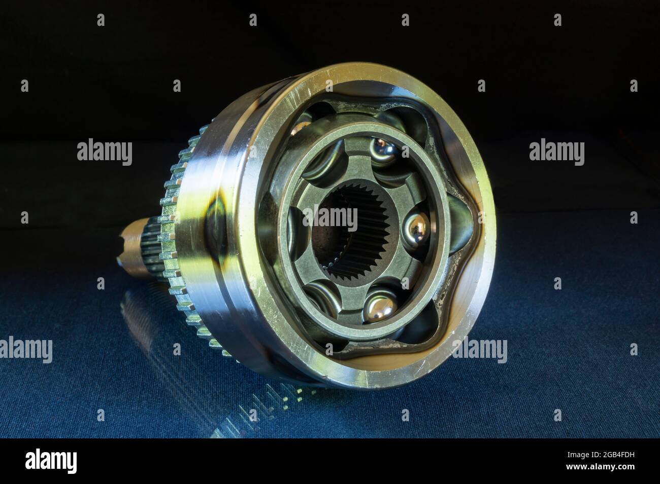 A bearing of equal angular velocities for a car. Metal details on a black background.New parts for repair Stock Photo