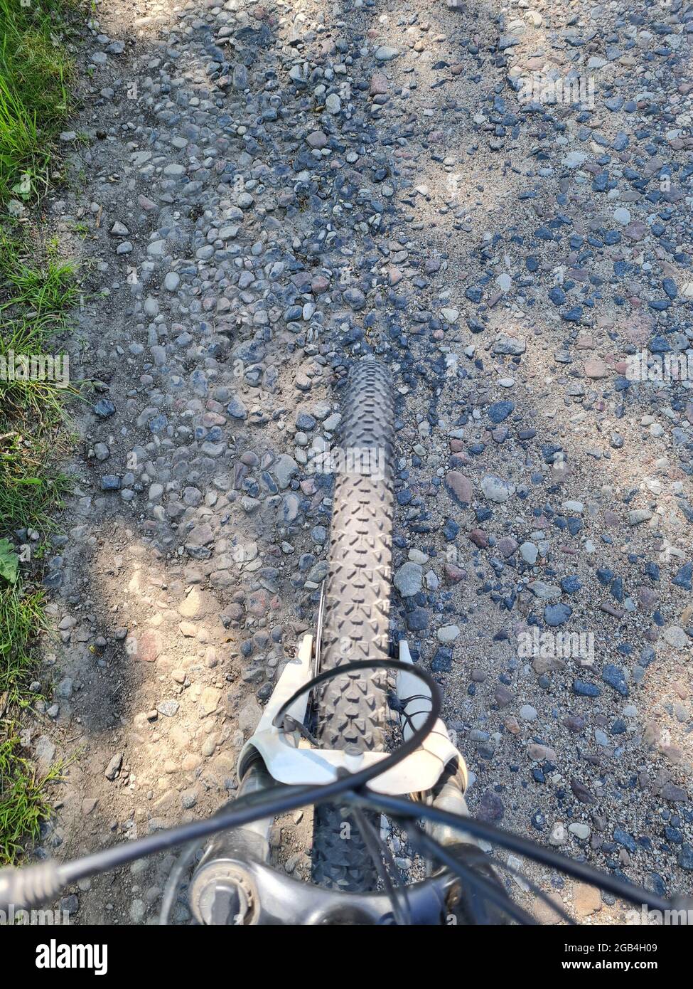 bicycle wheel on gravel road background closeup Stock Photo Alamy
