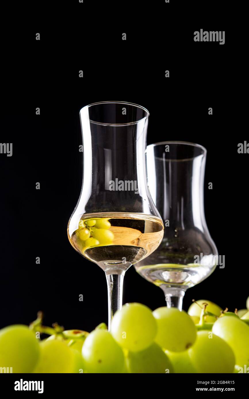 Italian golden grappa drink on wooden table Stock Photo