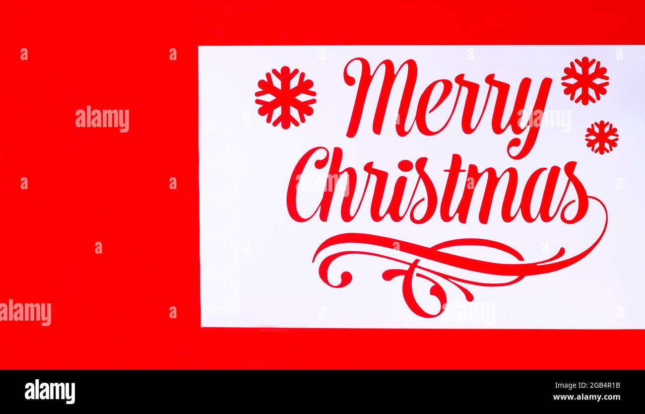 Stencil with the inscription Happy Christmas, on a red background, horizontally, no people, Christmas wallpaper, Stock Photo