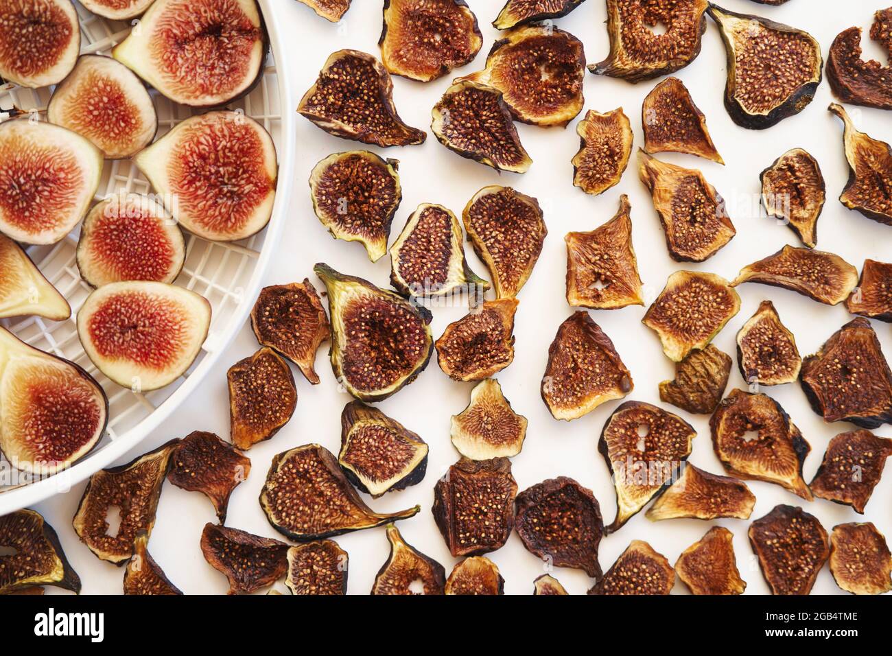 Dried figs lie next to fresh ones on a plate on the table Stock Photo