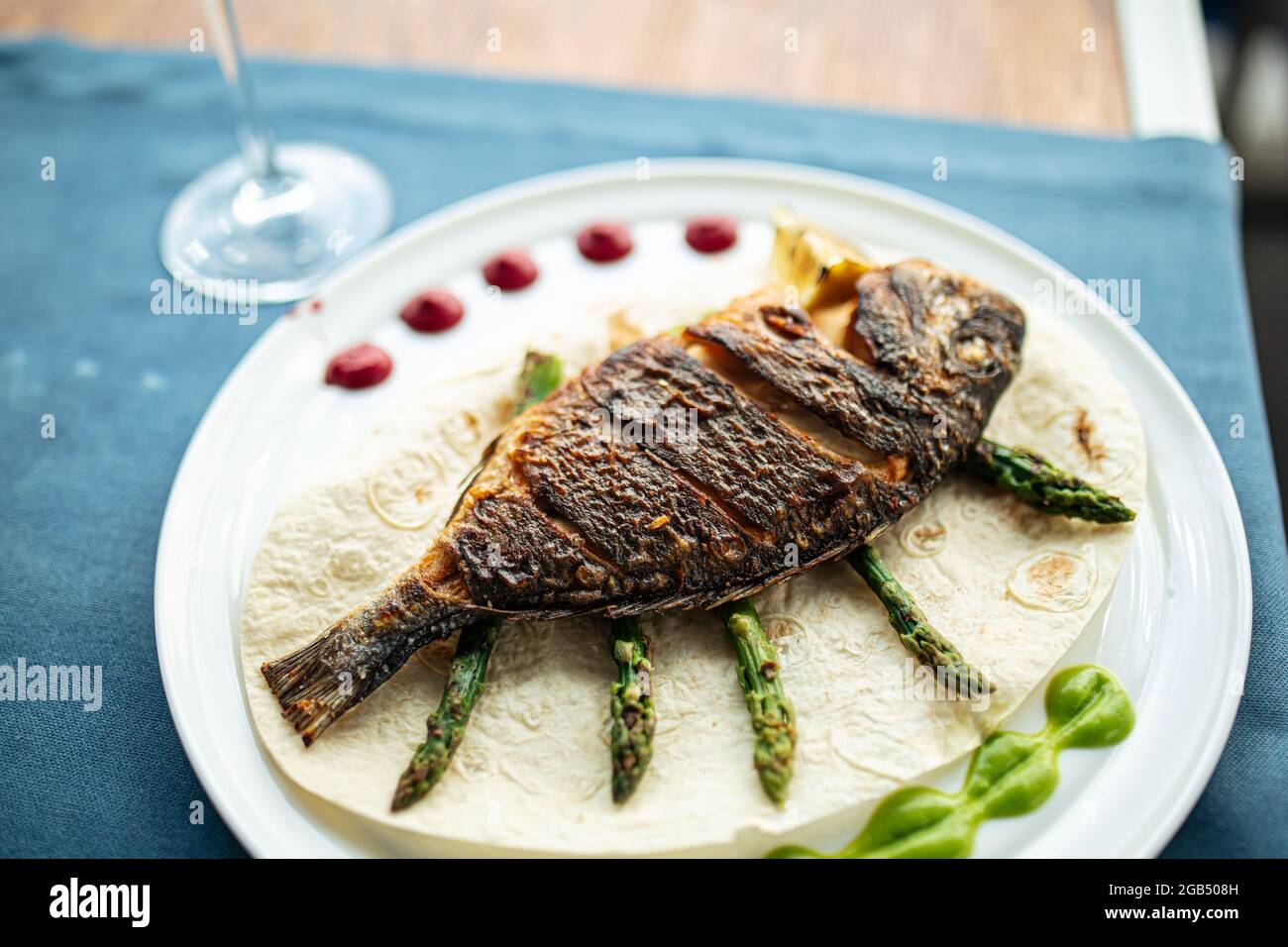Dish of gourmet grilled dorada fish Stock Photo - Alamy