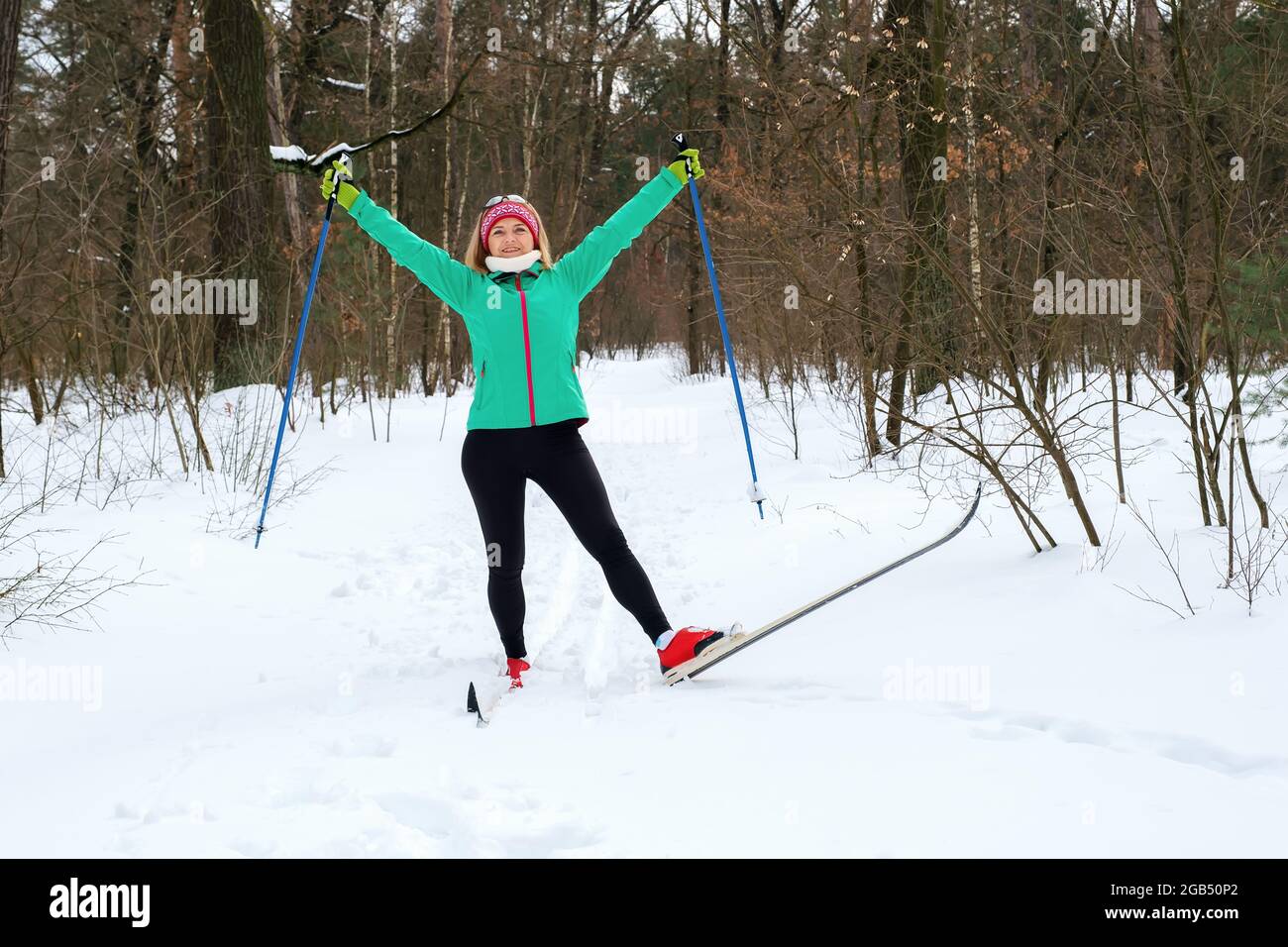 Woman goes cross-country skiing in the winter in the forest Stock Photo