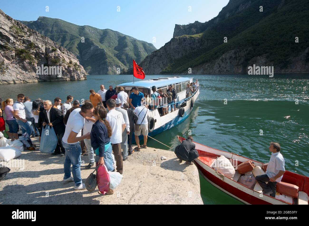 people and tourists in northen of Albania lake Koman docking of the ferry boat for pick-up of passengers from Fierze to Koman and back - August, 2012 Stock Photo