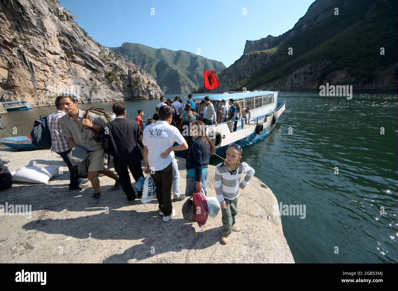 people and tourists in northen of Albania lake Koman docking of the ferry boat for pick-up of passengers from Fierze to Koman and back - August, 2012 Stock Photo