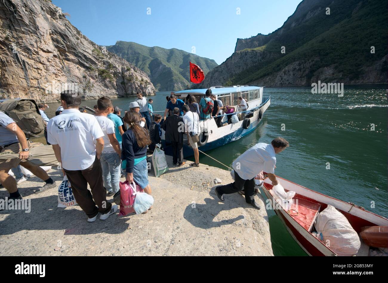 people and tourists in northen of Albania lake Koman docking of the ferry boat for pick-up of passengers from Fierze to Koman and back - August, 2012 Stock Photo