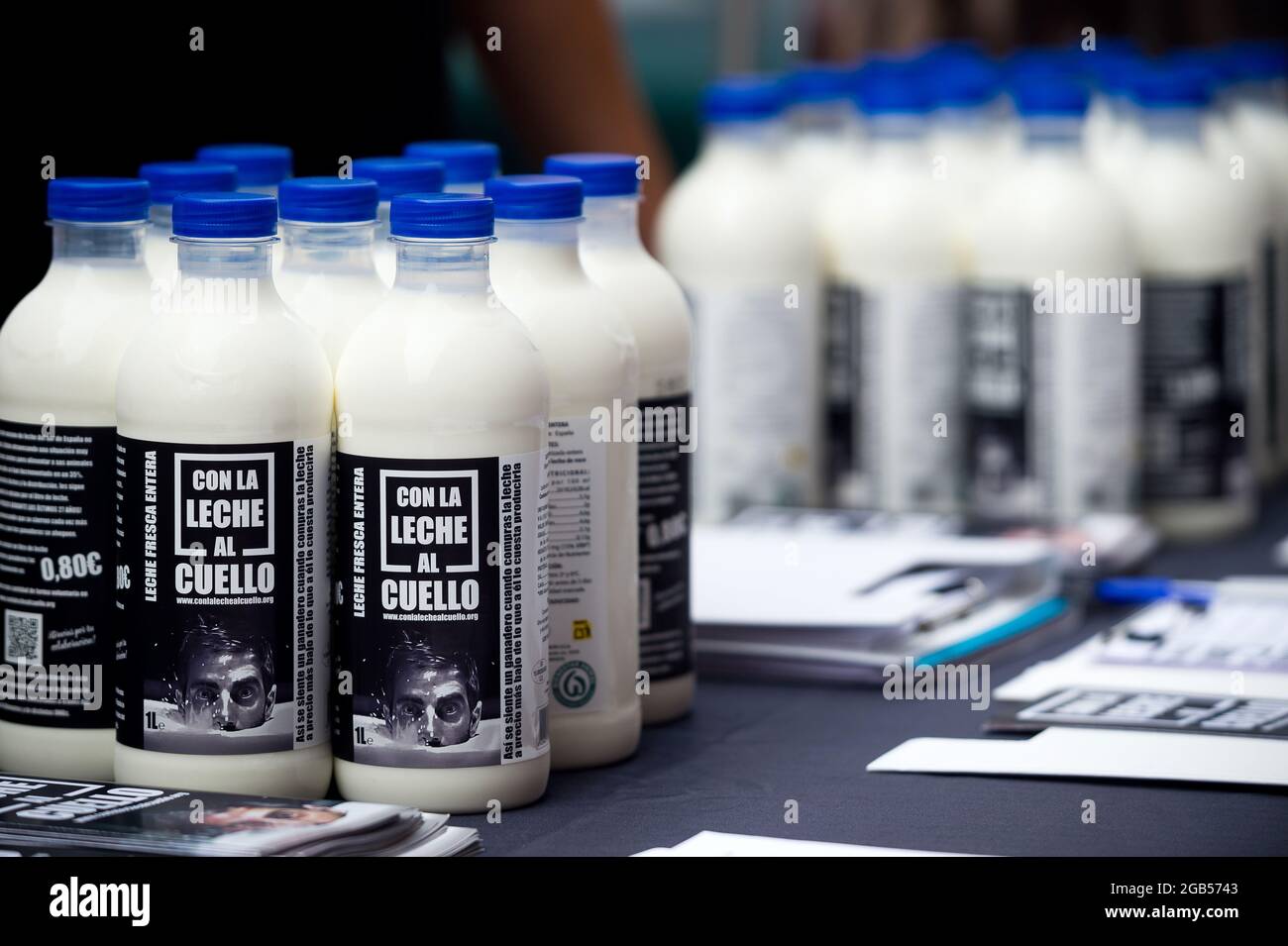 Milk bottles seen displayed during the protest of livestock sector in front  of LIDL supermarket.A group of ranchers from milk sector alert about crisis  of the sector in southern Spain, due to