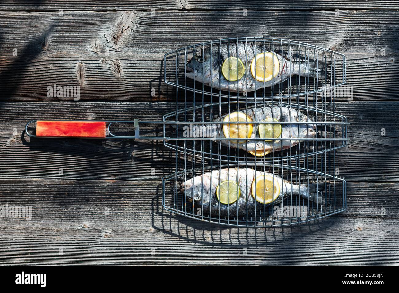 Prepared for grilling dorada fish on wood table. Food photography Stock Photo