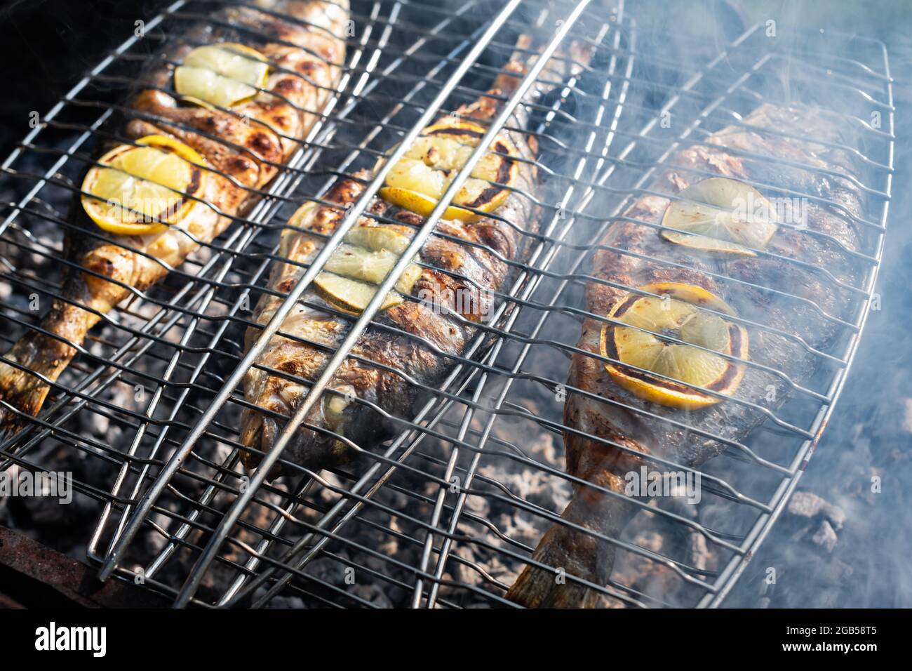 Grilling dorada fish on grill. Food photography Stock Photo