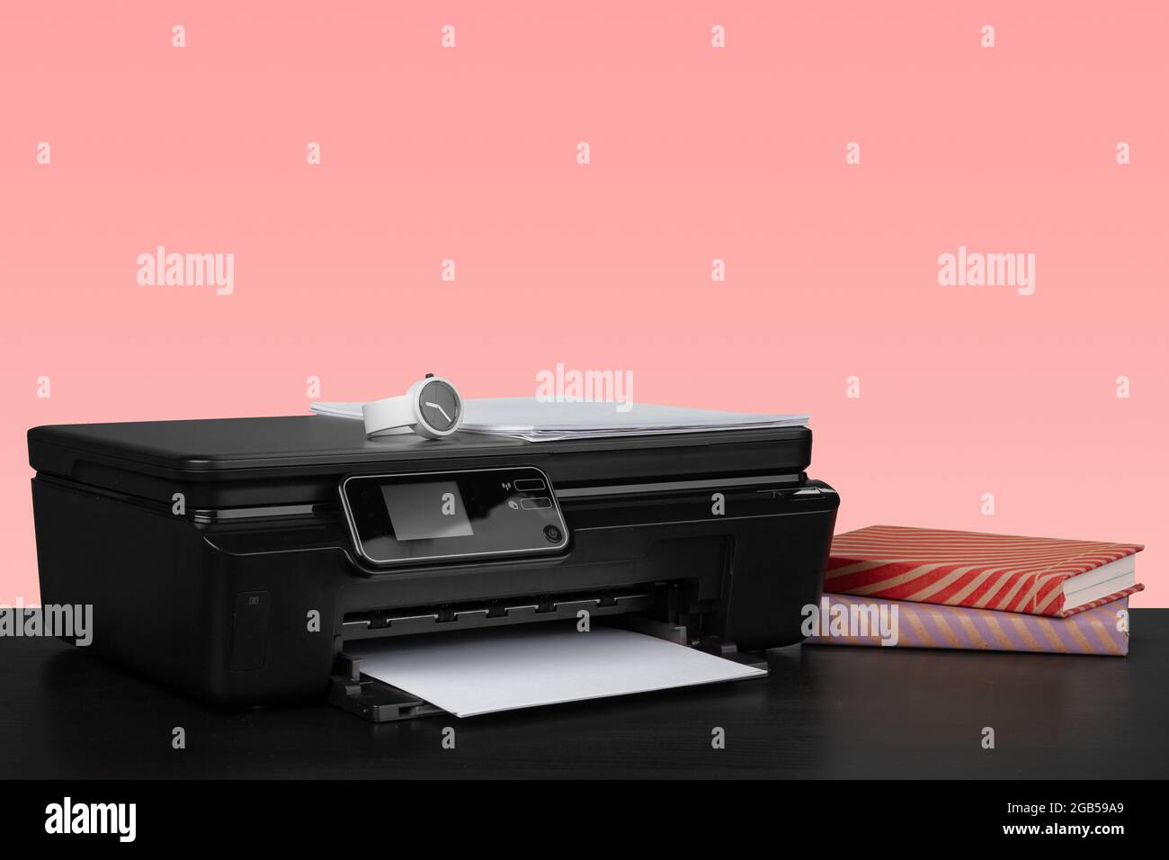 Compact home laser printer against pink background Stock Photo