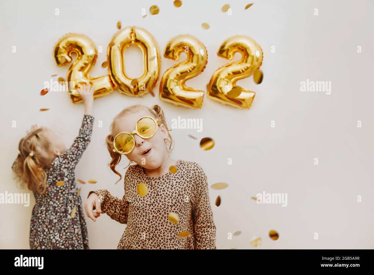 Preparing For Christmas 2022 Two Little Girls Decorate The Wall Of The House With The Numbers 2022 With  Foil Balls On Christmas Eve And New Year's Eve Preparing The House For Chri  Stock Photo - Alamy