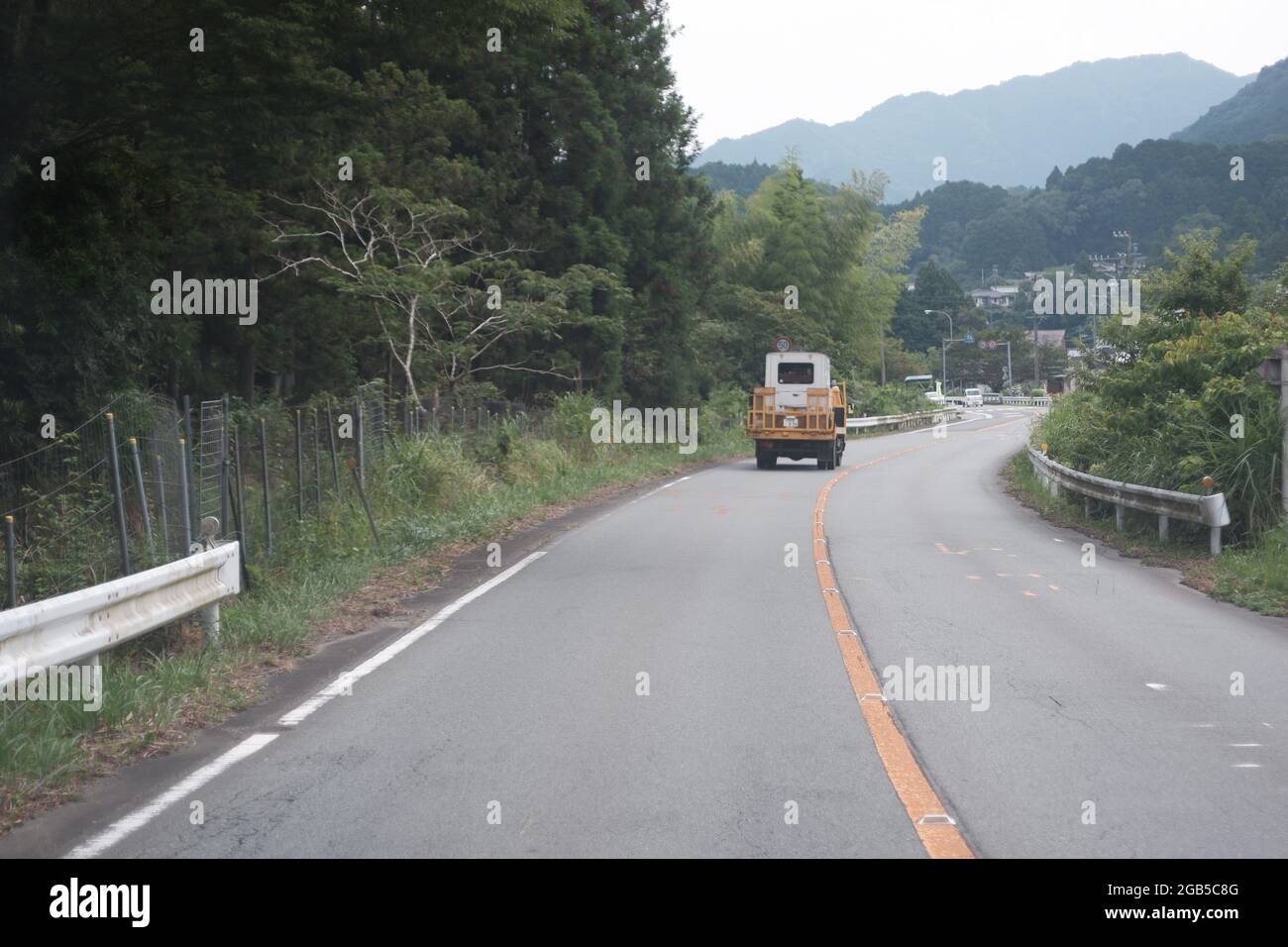 Car carrier trailer at a mountainous  rural road Stock Photo