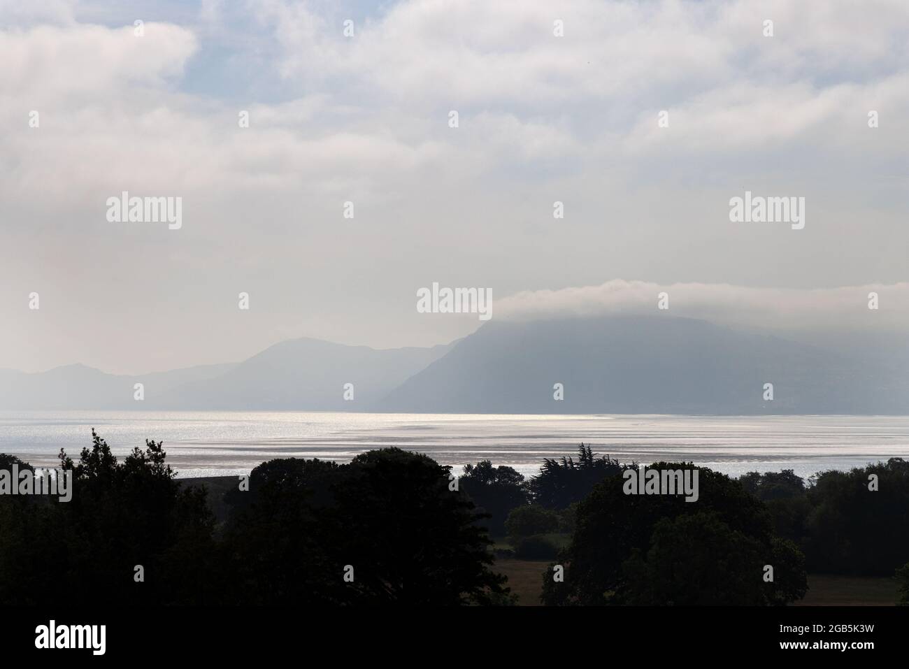 Wales landscape; Misty morning view from Anglesey across the Menai Strait to mainland Wales; Anglesey, Wales Britain UK Stock Photo