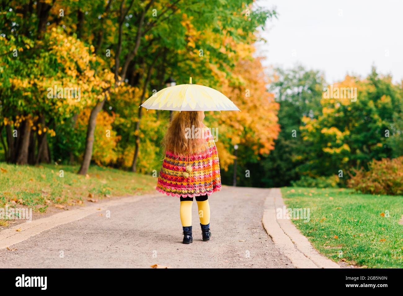 Happy child girl laughing with an umbrella in autumn park Stock Photo ...