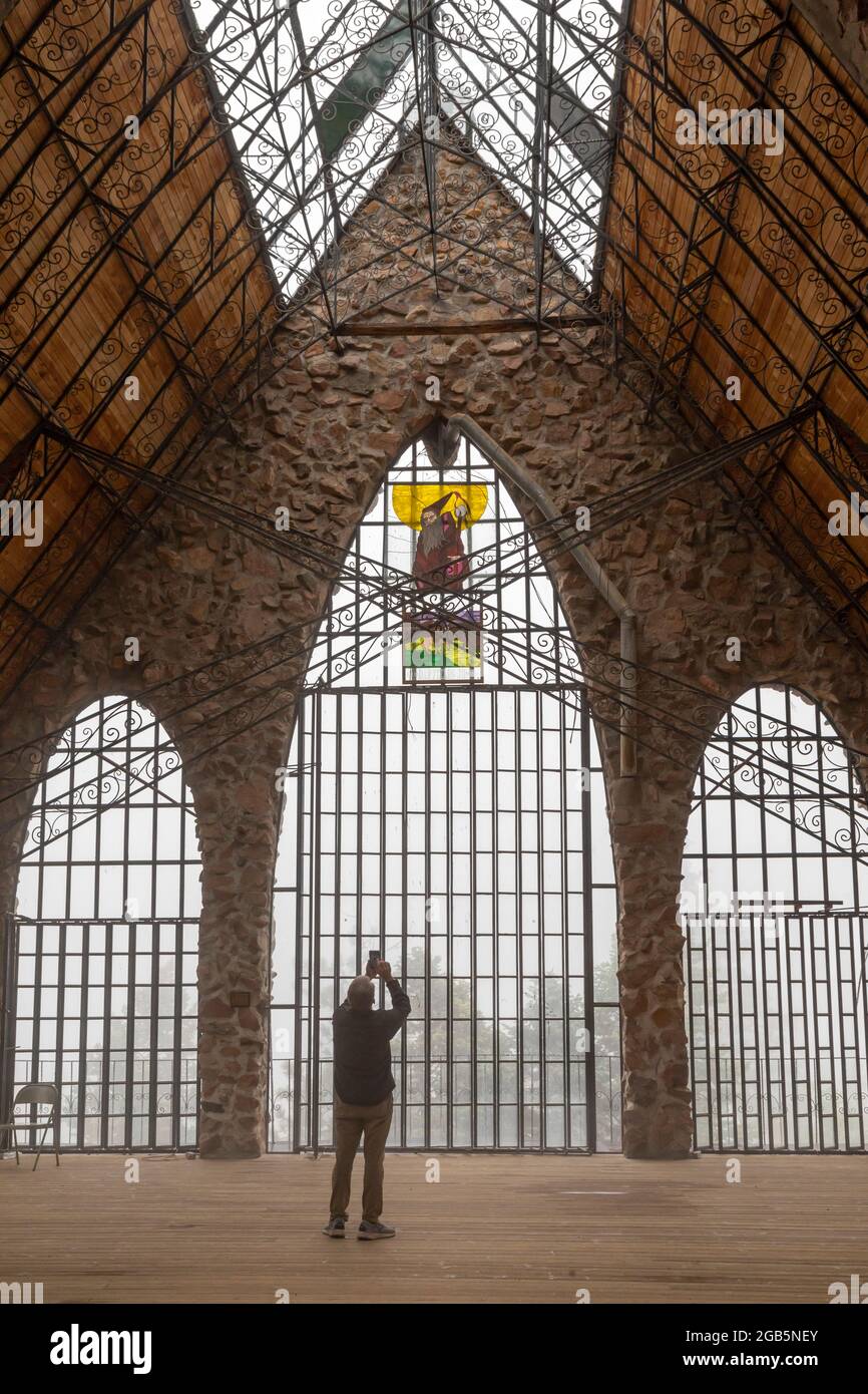 Rye, Colorado - A visitor photographs the Bishop Castle on a foggy ...