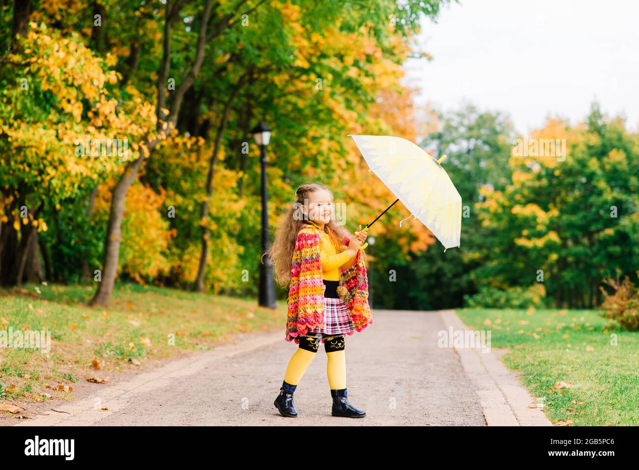 Happy child girl laughing with an umbrella in autumn park Stock Photo ...