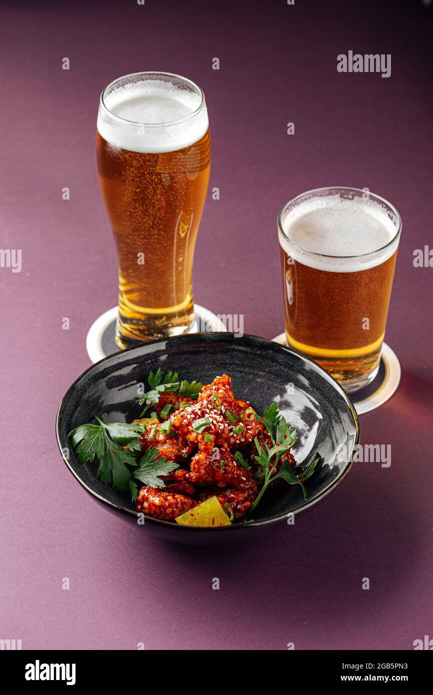 Japanese karaage chicken with beer on a purple Stock Photo