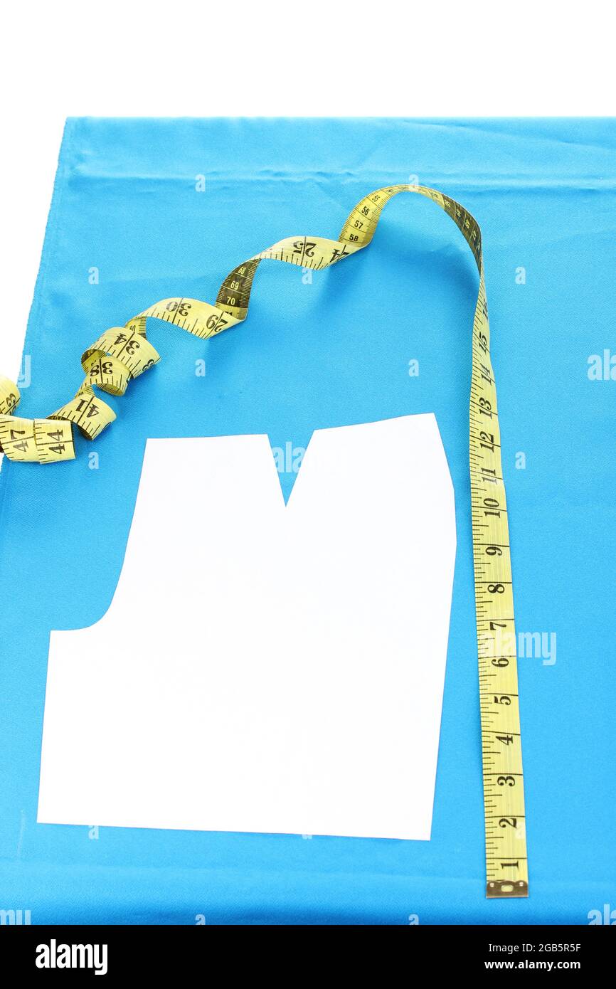 Measuring tape and pattern on fabric isolated on white Stock Photo Alamy