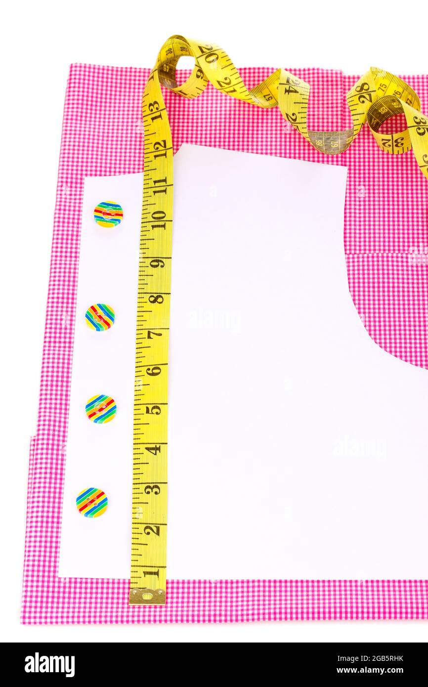 Measuring tape, buttons and pattern on fabric isolated on white Stock