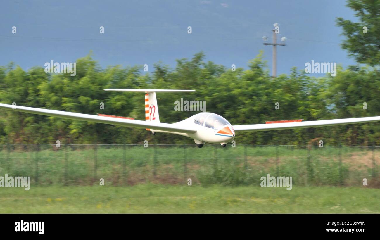 Thiene Italy, JULY, 8, 2021 Close up of a sailplane landing on a grass airstrip. Copy space.. Grob G103 Twin Astir Stock Photo
