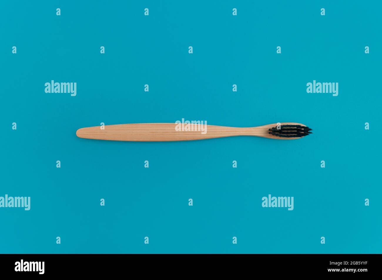 Wooden toothbrush on blue background Stock Photo