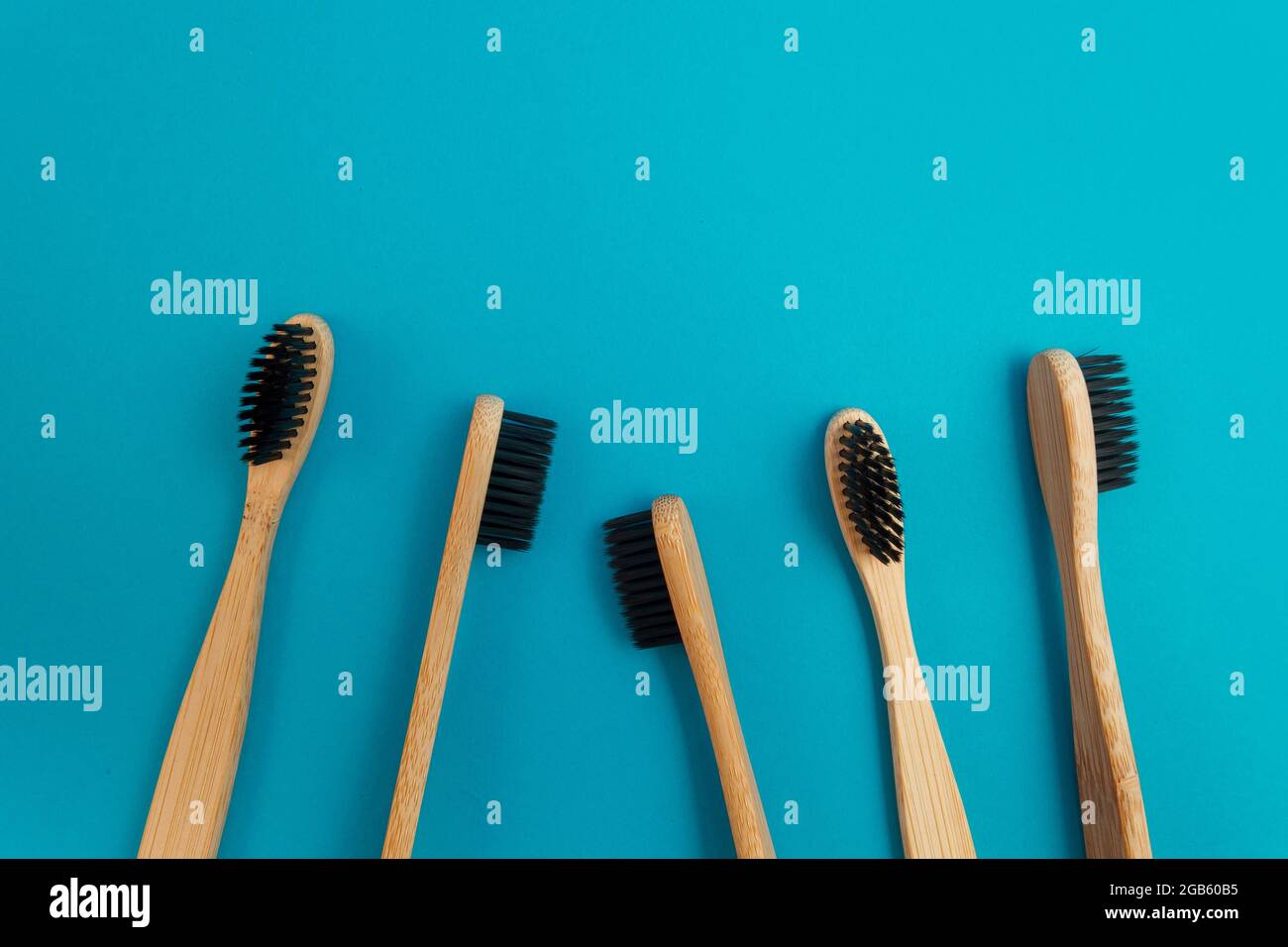 Wooden toothbrush on blue background Stock Photo