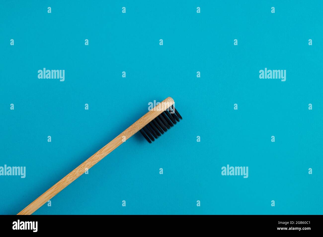 Wooden toothbrush on blue background Stock Photo