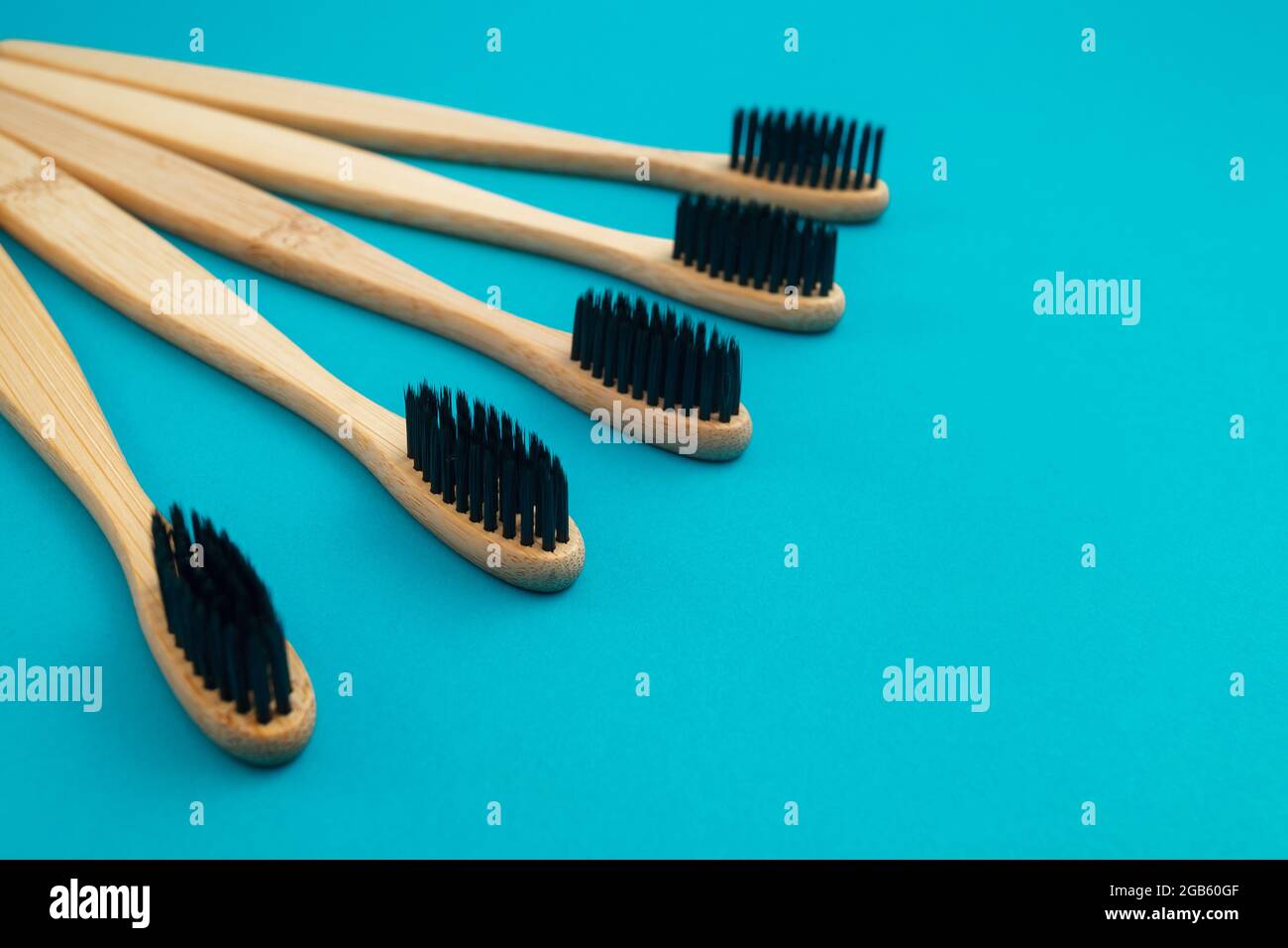 Wooden toothbrush on blue background Stock Photo