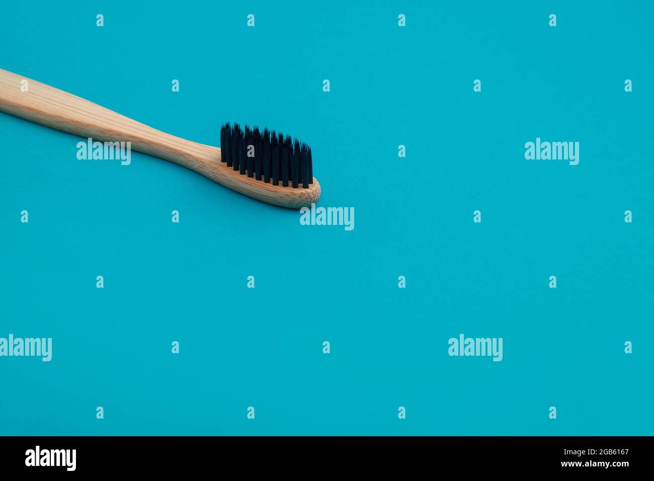 Wooden toothbrush on blue background Stock Photo