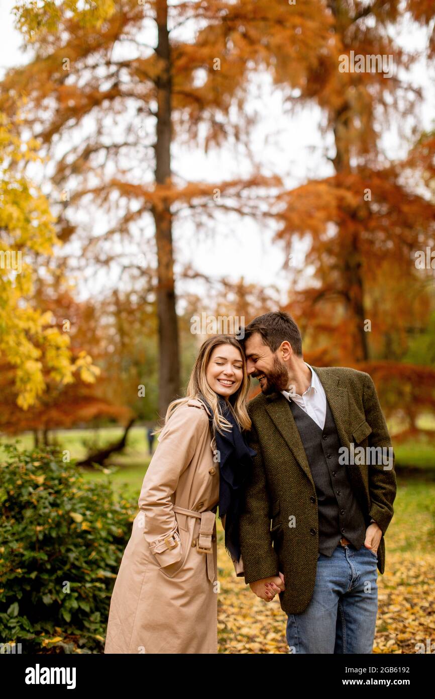 Handsome young couple in the autumn park Stock Photo - Alamy