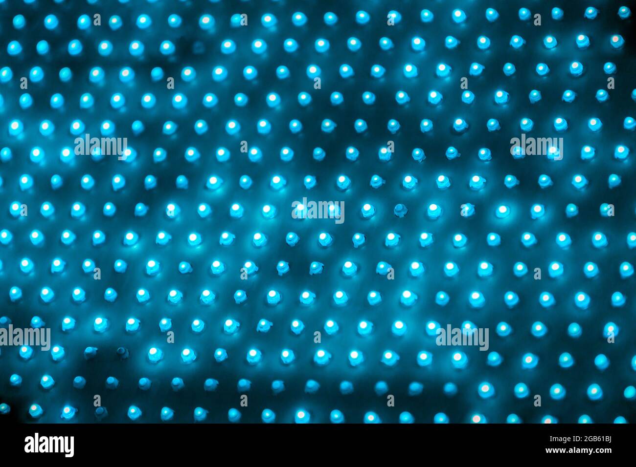 cheap outdoor blue led screen panel with individual diodes, full frame close-up view with selective focus. Stock Photo
