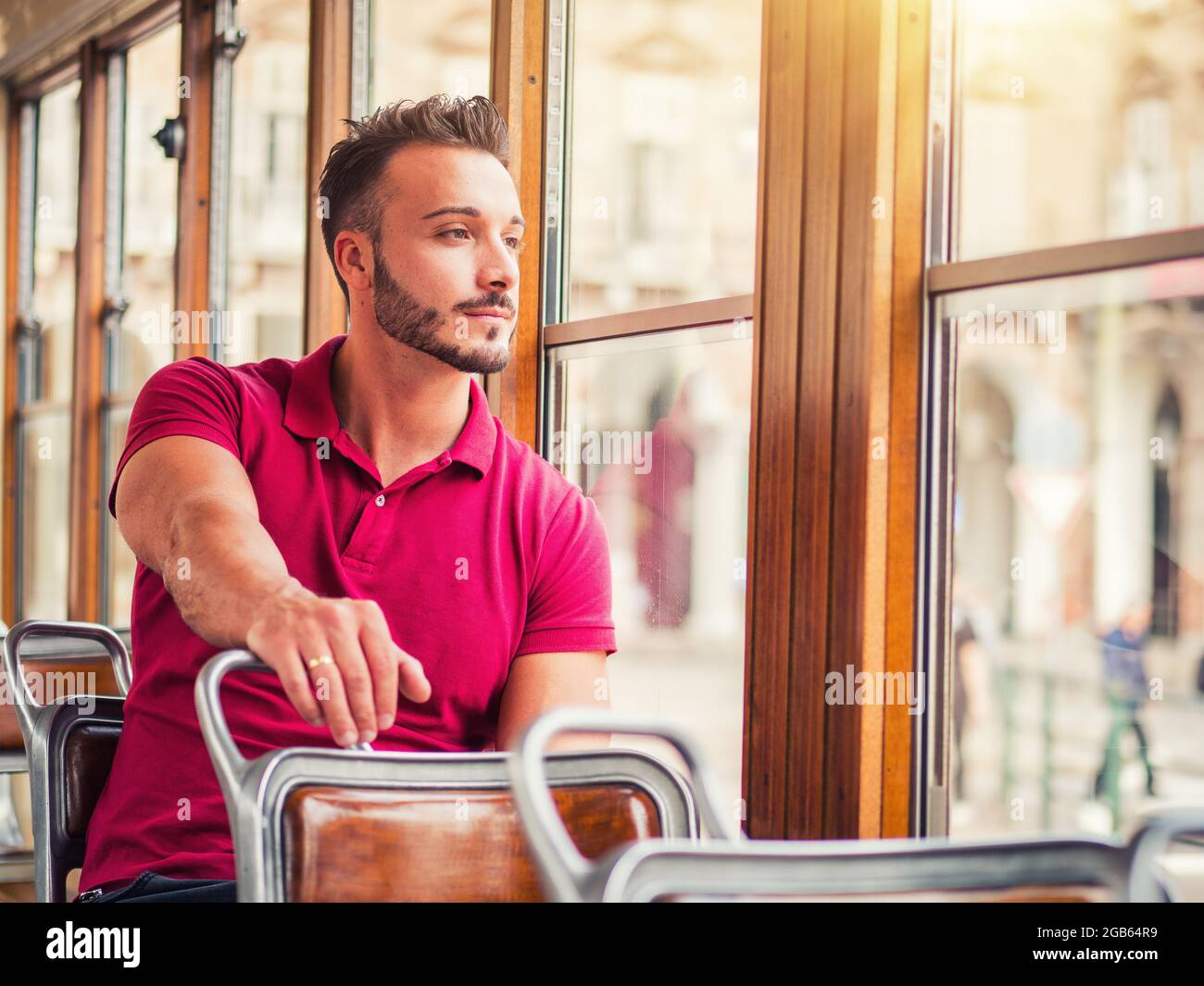 Young handsome man riding on tram or old bus in city Stock Photo