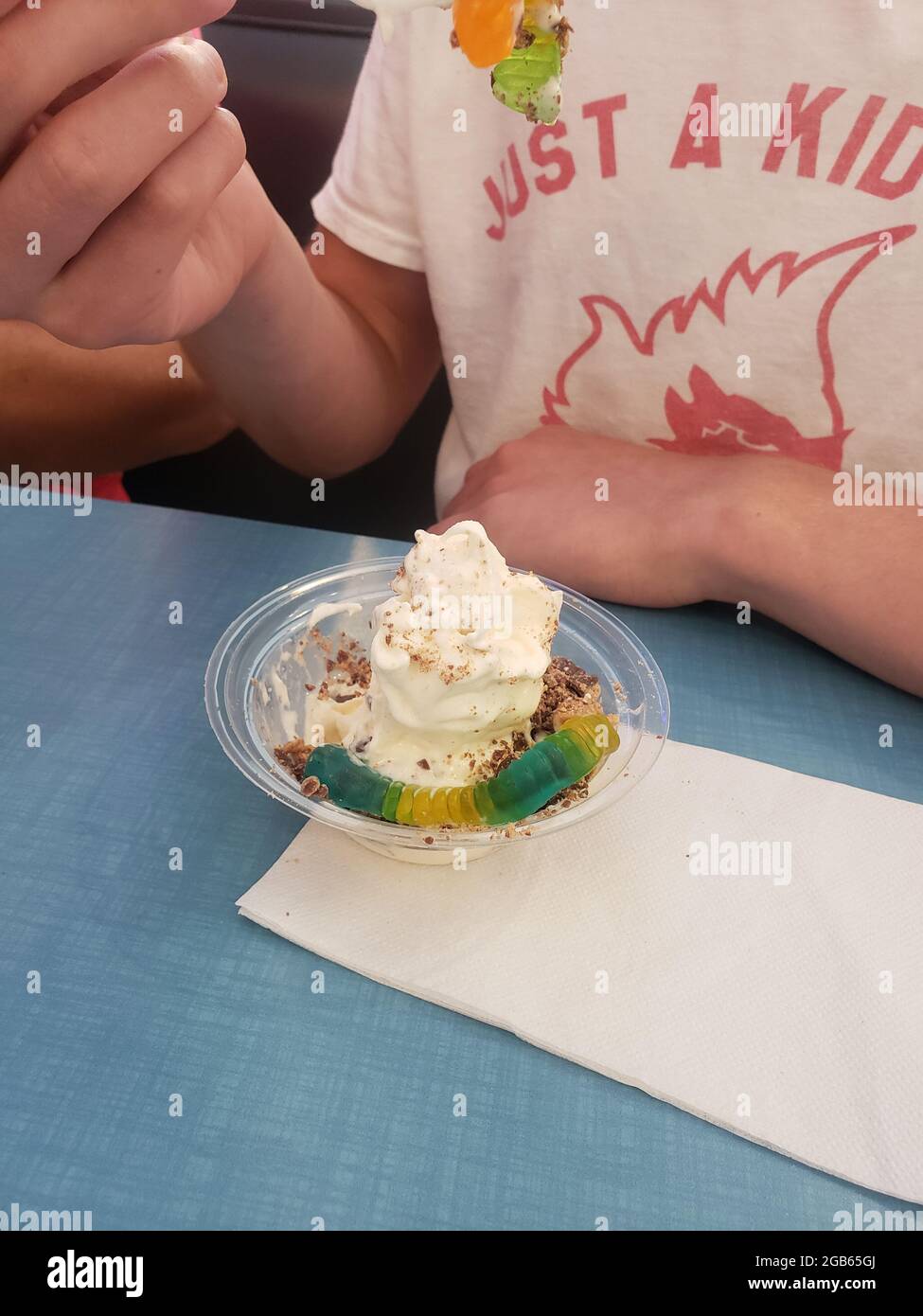 Boy Eating Ice Cream with Gummy Worms Stock Photo Alamy
