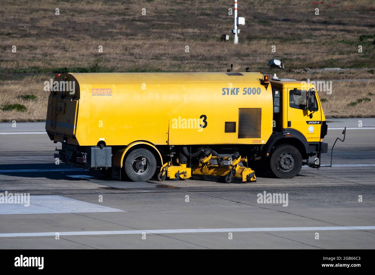 Istanbul, Turkey - March 28, 2019: Airport runway cleaning. Airfield concrete and asphalt surface cleaner. Snowplow. Snow and dirt removal tractor veh Stock Photo