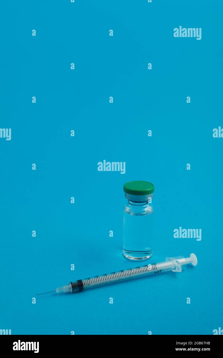 syringe ampoule with medicine on blue background Stock Photo Alamy