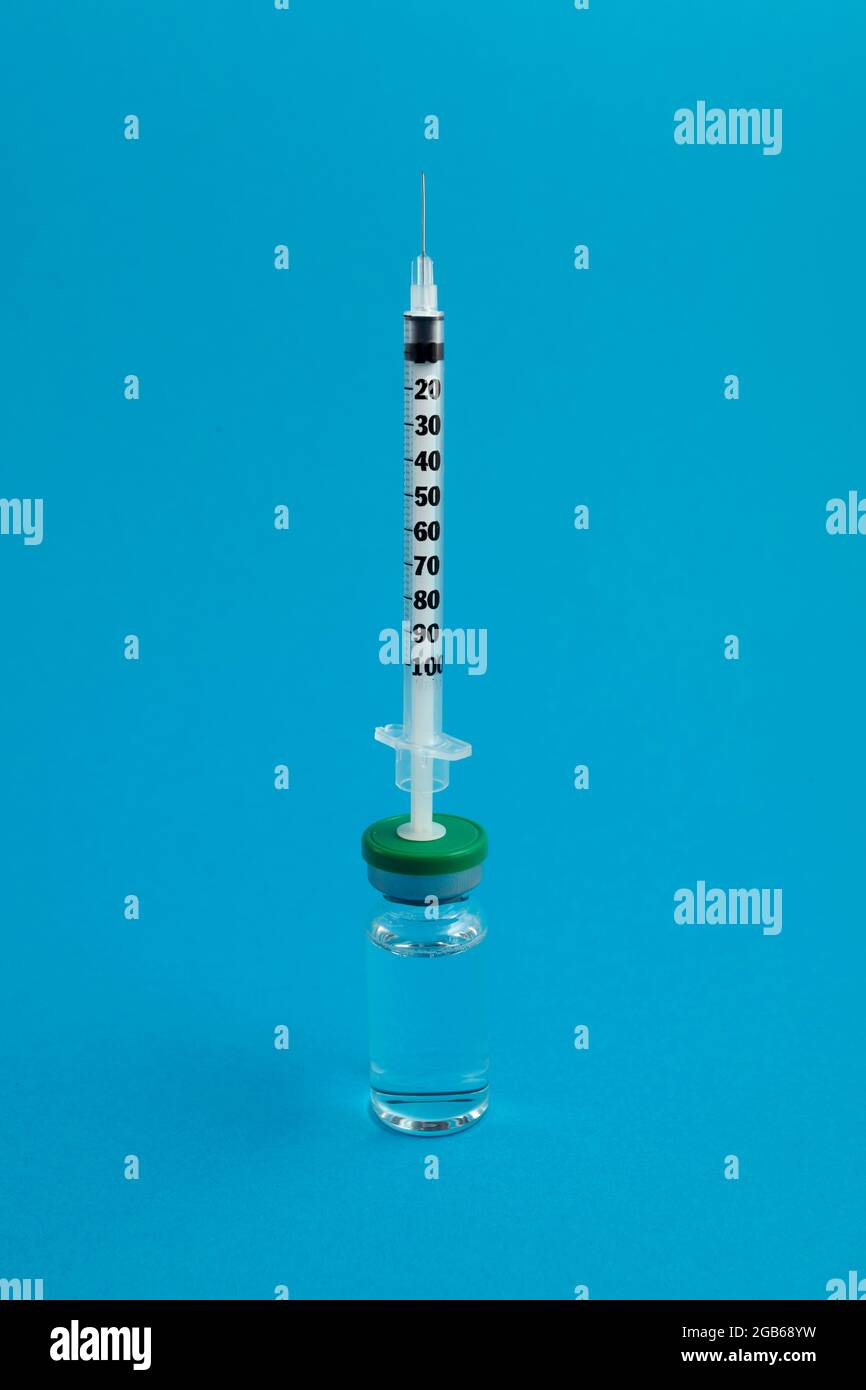 syringe ampoule with medicine on blue background Stock Photo Alamy