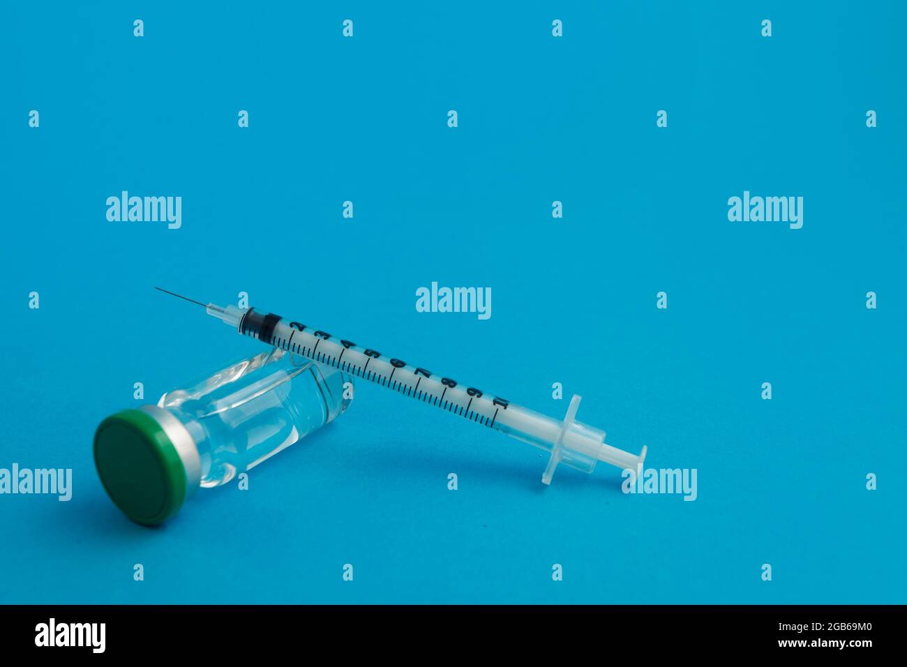 syringe ampoule with medicine on blue background Stock Photo Alamy
