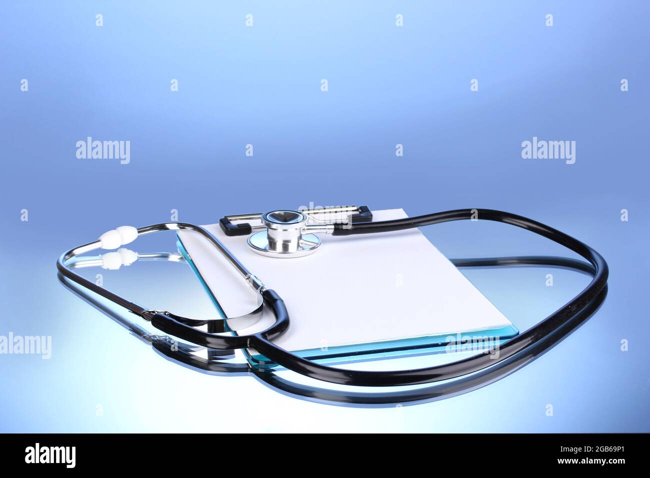 Medical stethoscope and clipboard on blue background Stock Photo - Alamy