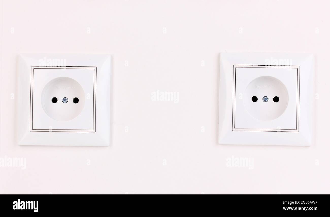 White electric sockets on the wall Stock Photo Alamy